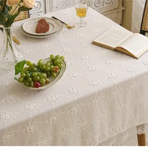 Elegant white lace tablecloth with detailed 3D floral embroidery and scalloped edges