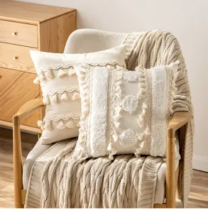 Detailed macro view of bohemian tassel throw pillow covers with tufted circular patterns