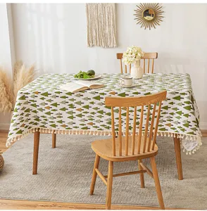 Detailed view of tree print tablecloth with elegant fringe tassels in a dining room
