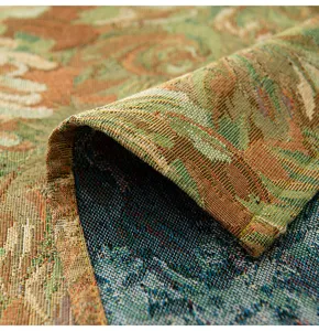 Macro shot of a vintage jacquard tablecloth showing detailed woven floral textures.