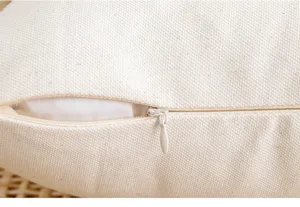 Macro detail of high-quality invisible zipper on beige linen-textured cushion cover