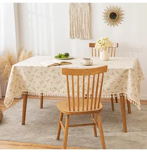 High-quality floral cotton linen tablecloth with tassel edges in a warm dining room scene