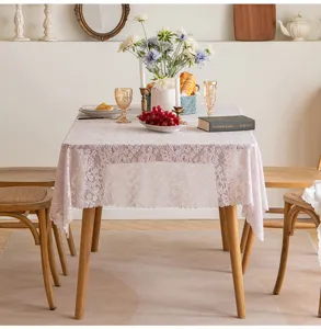 Elegant rectangular pink floral lace tablecloth in a rustic French country dining room setup