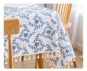 Close-up of blue floral printed cotton linen tablecloth with elegant tassels
