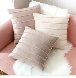 Soft velvet decorative pillow covers with elegant horizontal stripes on a cozy sofa