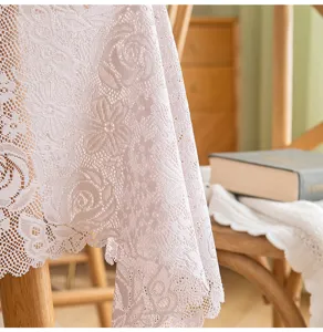 Detailed close-up of French lace tablecloth featuring an elegant hollow rose pattern