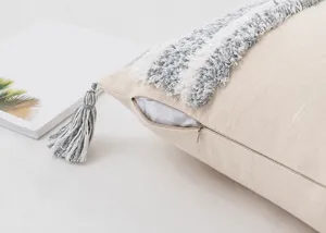 Close-up of hidden zipper on bohemian tufted cushion cover with tassels.
