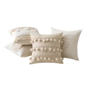 Set of bohemian cream throw pillow covers with decorative pom-poms and tassels