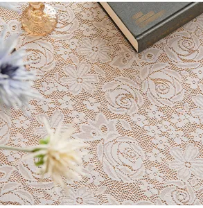 Detailed view of elegant French lace tablecloth with intricate rose floral mesh pattern