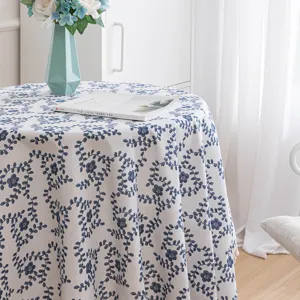Elegant round cotton tablecloth featuring blue floral patterns in a cozy home setting