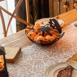 White Halloween lace table runner with intricate spider web pattern for party decor