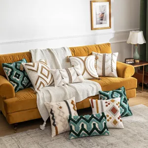 Decorative Bohemian tufted pillowcases with Moroccan patterns on a cozy yellow sofa