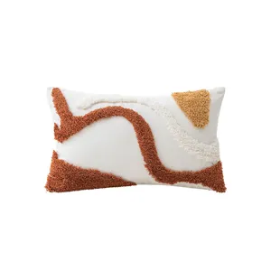 Abstract tufted lumbar pillow cover with geometric earthy tone patterns