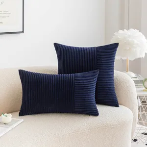 Modern navy blue corduroy patchwork pillowcases set on a stylish textured beige sofa