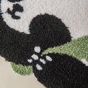 Macro view of high-density tufted embroidery texture on cute panda decorative pillow