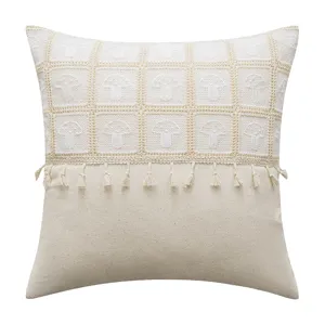 Cream crochet mushroom pattern pillowcase with decorative tassel fringe details on white background