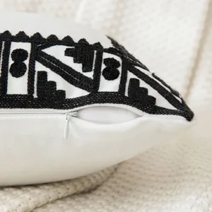 Close-up of white geometric embroidered pillowcase with a high-quality hidden zipper