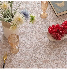 Exquisite close-up of the hollow floral pattern on a vintage French-style lace tablecloth