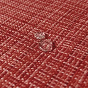 Vista macro de tela impermeable para funda de cojín de exterior con gotas de agua