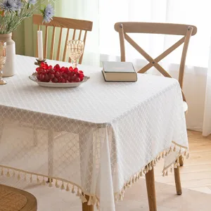 Elegant white French lace tablecloth with tassels and hollow-out floral pattern