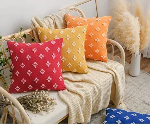 Cozy lifestyle scene with colorful star-patterned tufted cotton cushion covers on a rattan chair.