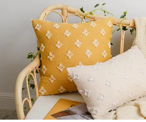 Detailed texture of star tufted cotton cushion covers on a boho rattan chair