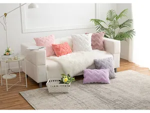Detail view of colorful plush Nordic wave pattern pillow covers arranged on a white sofa.
