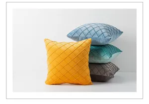 Detail of lattice velvet cushion covers in yellow blue teal and grey