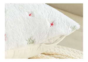 Detailed macro shot of white plush snowflake embroidered pillow cover with hidden zipper