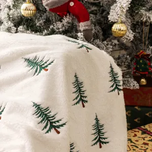 Zachte witte pluche deken met geborduurde kerstboom voor feestelijke bankdecoratie.
