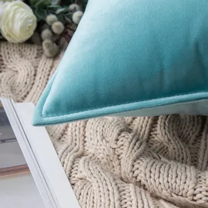 Close-up detail of soft teal velvet cushion cover featuring elegant flanged edge design