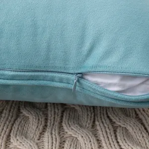 Close-up of a soft teal velvet cushion cover featuring an invisible zipper detail.