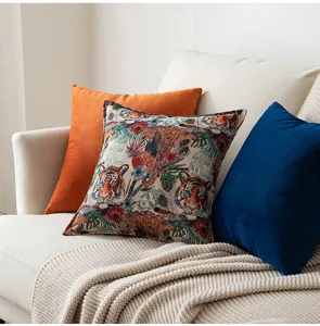 Close-up of vintage tiger jacquard pillow with velvet cushions on a cozy beige sofa
