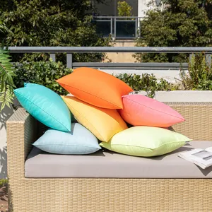 Vibrant set of six waterproof solid color outdoor cushion covers on a wicker patio sofa