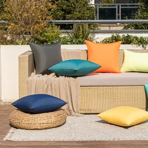 Vibrant set of colorful outdoor waterproof pillow covers on a stylish garden patio sofa