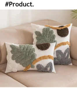 Detailansicht tuftierter Boho-Kissenbezüge mit abstrakten Naturmotiven auf einem Sofa