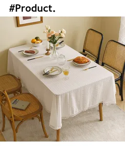 Detailed view of elegant white lace tablecloth with floral embroidery in a home setting