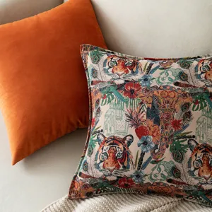 Artistic tiger jacquard and burnt orange velvet throw pillows on a neutral sofa