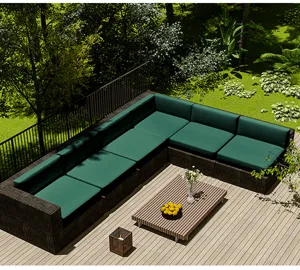 Green waterproof outdoor cushion covers displayed on an L-shaped rattan garden sofa.