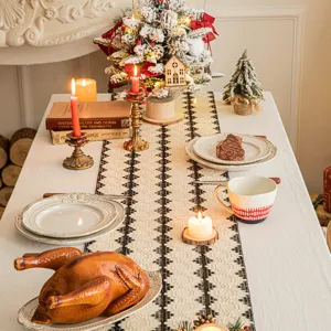 Festive cotton-linen table runner with black geometric woven patterns on dining table