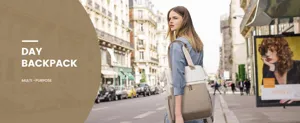 Stylish women's minimalist laptop backpack worn on a busy European city street.