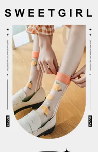 Detailed view of breathable glass silk socks with yellow floral patterns and orange cuffs