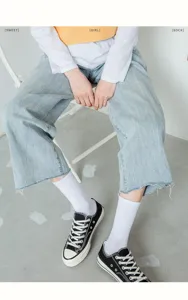 Detail shot of soft white cotton mid-tube socks paired with stylish canvas shoes.