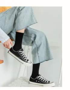 Comfortable black cotton crew socks for men and women, classic casual daily wear detail view.