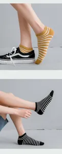 Detailed macro view of comfortable cotton striped low-cut socks for women in yellow and black