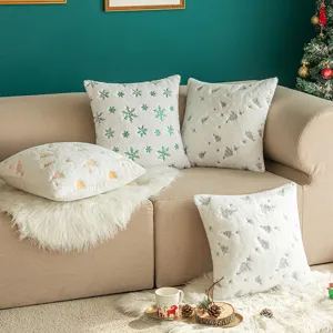 White plush Christmas pillow covers with green snowflake and silver tree embroidery