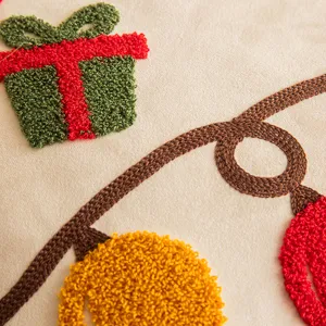 High-quality close-up of tufted Christmas embroidery on a cream festive cushion cover