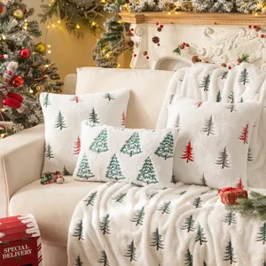 Festive plush pillow covers with embroidered Christmas trees and matching throw.