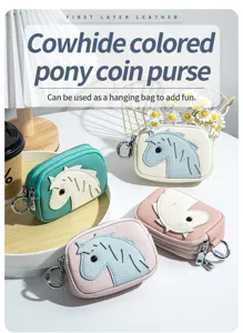Multiple colors of cowhide leather pony coin purses with double zippers shown on a desk