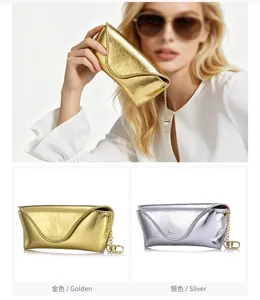 Detail view of metallic crackle leather sunglasses cases in gold and silver colors.